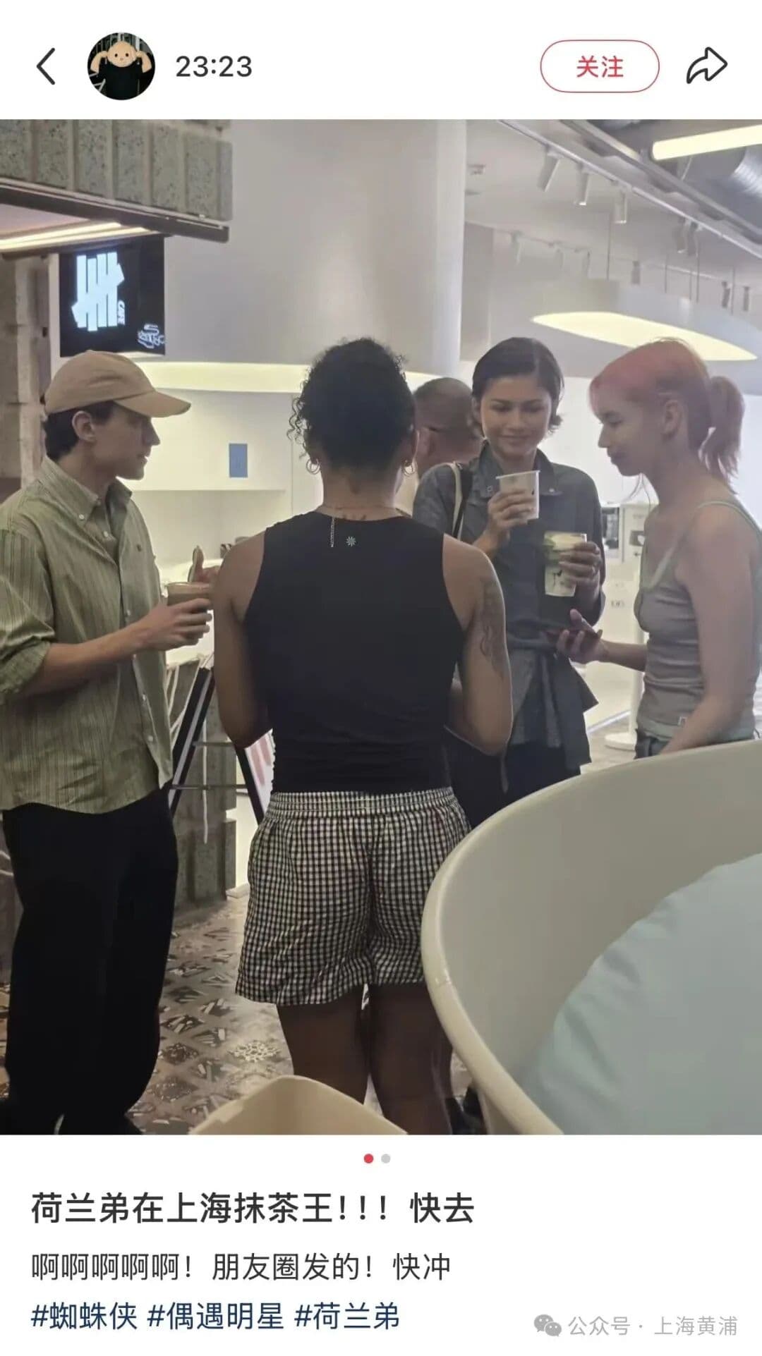 Zendaya and Tom Holland holding drinks inside UNDEFEATED CAFE at HAI550